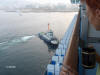 Tug boat pushing ocean liner
