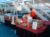 cruise ship drinks pictures of the crew setting up a display to sell ugly monkey drink cups